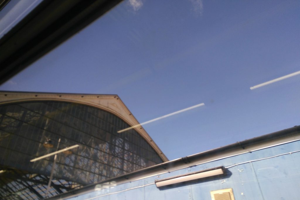 Brighton train station's arched roof, seen through a train window