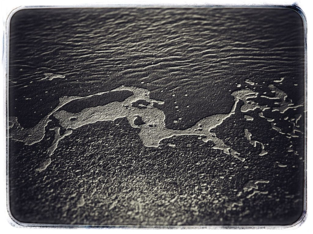 Abstract monochrome image of foam on ripples